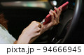 woman use smartphone connecting car 94666945