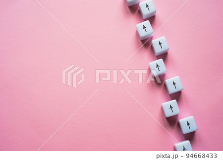 Chain of arrows blocks on a pink background. Concept of conformism, vertical of power. Consistency and focus. Unchanging course of development. Education and skill growth. Building a solid strategy. Chain of arrows blocks on a pink background. Concept of conformism, vertical of power. Consistency and focus. Unchanging course of development. Education and skill growth. Building a solid strategy. 94668433