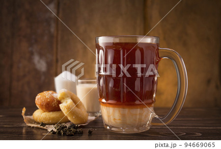 thai milk tea drink with sweet donuts , thai beverage 94669065
