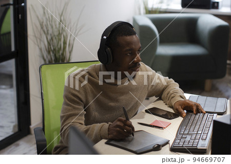 African American artist draws on tablet 3D model for computer game African American artist draws on tablet 3D model for computer game 94669707