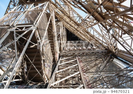 Inside the Eiffel tower. Close up of the iron structure. Distinctive symbol and famous tourist attraction of Paris, France, selective focus 94670321