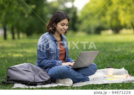Distance Learning. Young Middle Eastern Female Student Study With Laptop Outdoors Distance Learning. Young Middle Eastern Female Student Study With Laptop Outdoors 94671229
