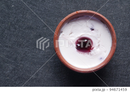 fresh blueberry yogurt in a bowl on table fresh blueberry yogurt in a bowl on table 94671459