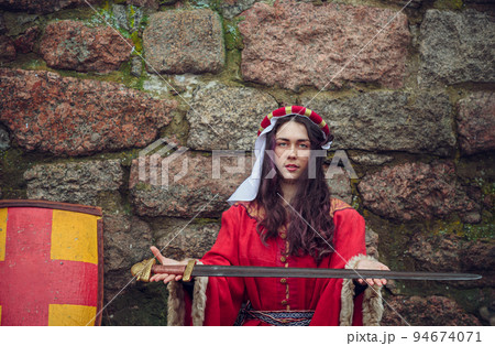 a young girl offers a soldier to take up sword and shield a young girl offers a soldier to take up sword and shield 94674071