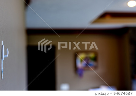 Selective focus on adhesive strip wall hanger that can be removed by pulling tape 94674637