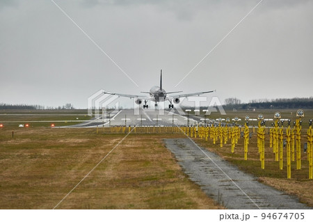 Plane landing on runway 94674705