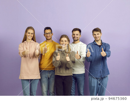 Portrait of smiling young people show thumbs up 94675360