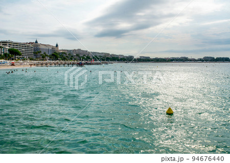 Amazing on Mediterranean sea from Croisette - people swimming . At far distamce bif shipcruiser on park Amazing on Mediterranean sea from Croisette - people swimming . At far distamce bif shipcruiser on park 94676440