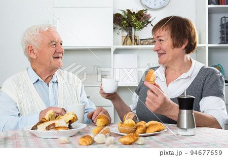 Elderly couple having breakfast Elderly couple having breakfast 94677659