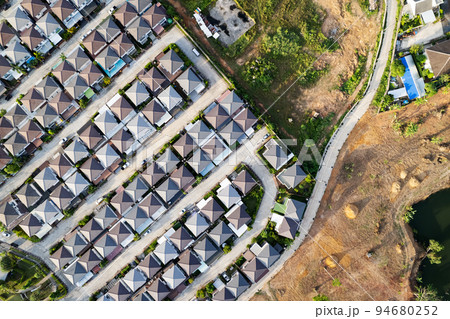 New development real estate. Aerial view of residential houses and driveways neighborhood during a fall sunset or sunrise time.Tightly packed homes.Top down view over private houses in phuket thailand New development real estate. Aerial view of residential houses and driveways neighborhood during a fall sunset or sunrise time.Tightly packed homes.Top down view over private houses in phuket thailand 94680252