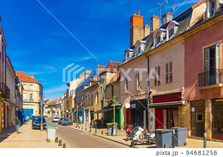 Summer cityscape of Dijon with narrow street and typical townhouses Summer cityscape of Dijon with narrow street and typical townhouses 94681256