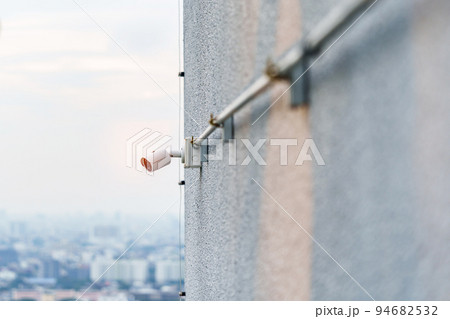 Modern CCTV camera against city and sky background. surveillance, video record and monitoring concept 94682532