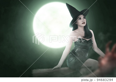 Asian witch woman with hat flying on a magic broomstick 94683294