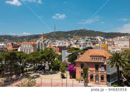 View from a rooftop of typical living area in Barcelona with antenna and mountain at the background 94685958