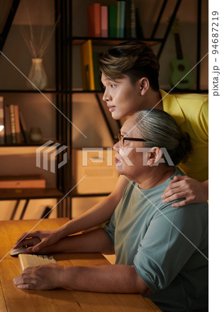 Grandmotehr and grandson searching for information on internet Grandmotehr and grandson searching for information on internet 94687219