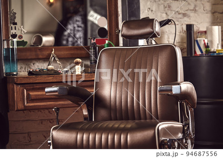 Barbershop armchair. Modern hairdresser and hair salon, barber shop for men. Barbershop armchair. Modern hairdresser and hair salon, barber shop for men. 94687556
