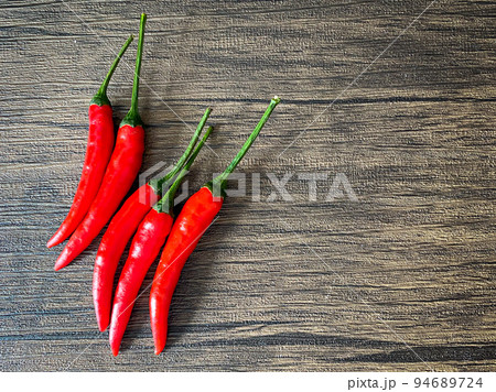 Fresh red chili and space for text on wooden background 94689724