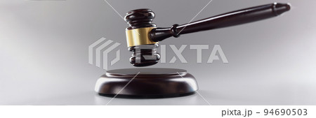 Judges wooden hammer on soundboard placed grey background Judges wooden hammer on soundboard placed grey background 94690503