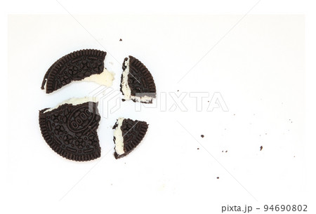 Sandwich chocolate cookies with a sweet cream with crumbs isolated on white background 94690802