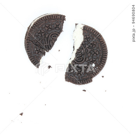 Sandwich chocolate cookies with a sweet cream with crumbs isolated on white background Sandwich chocolate cookies with a sweet cream with crumbs isolated on white background 94690804