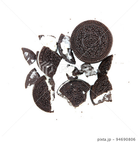 Sandwich chocolate cookies with a sweet cream with crumbs isolated on white background Sandwich chocolate cookies with a sweet cream with crumbs isolated on white background 94690806