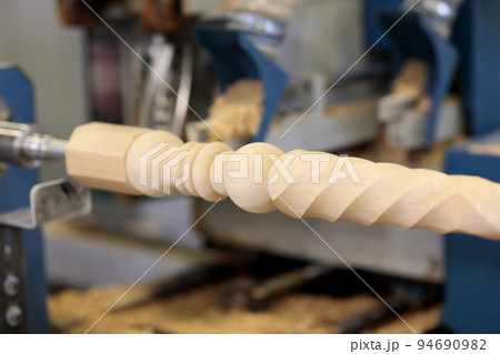 CNC wood lathe machine carving a railing pillar CNC wood lathe machine carving a railing pillar 94690982