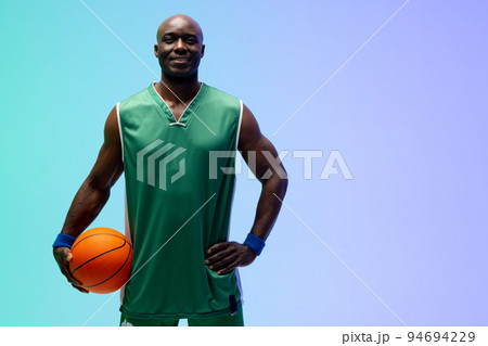 Image of smiling african american basketball player with basketball on green to blue background Image of smiling african american basketball player with basketball on green to blue background 94694229