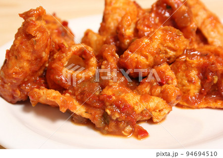 Fried Pork Skins With Red Salsa in Rustic Kitchen 94694510