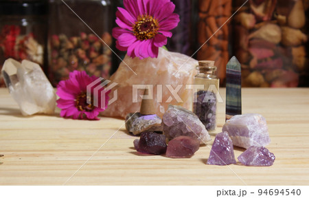 Amethyst Crystals With Flowers and Incense Cones on Meditation Table 94694540