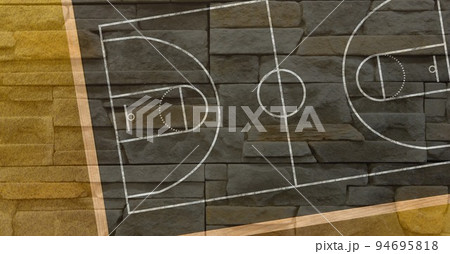 Composition of brown and black basketball court overhead view over textured brick wall background 94695818