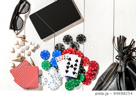 Poker. Set to playing poker with cards and chips on white wooden table, top view 94698254