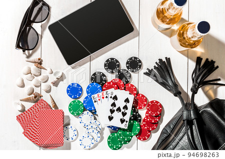 Poker. Set to playing poker with cards and chips on white wooden table, top view 94698263