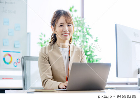 明るいオフィスで働くビジネスウーマン 明るいオフィスで働くビジネスウーマン 94698289