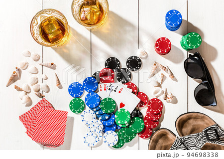 Poker. Set to playing poker with cards and chips on white wooden table, top view 94698338
