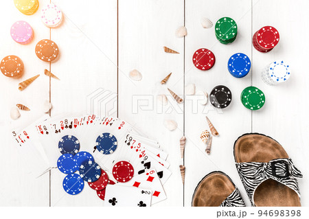 Gambling. Poker chips, cards and slippers on white wooden table. Top view. Copyspace. Poker. Gambling. Poker chips, cards and slippers on white wooden table. Top view. Copyspace. Poker. 94698398