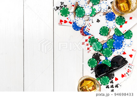 Gambling. Poker chips, cards and sunglasses on wooden table. Top view. Copyspace. Poker 94698433