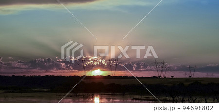 High voltage power line at sunset, Pampas, Argentina High voltage power line at sunset, Pampas, Argentina 94698802