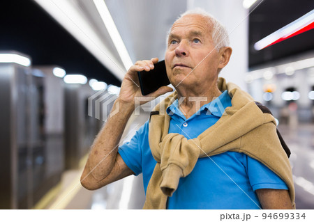 Senior man with phone in metro station 94699334