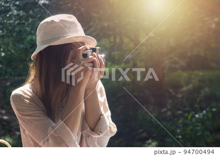 beautiful woman using Ancient camera work in capturing memories 94700494