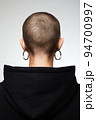 back of the head. Girl with short haircut. bald woman with earrings 94700997