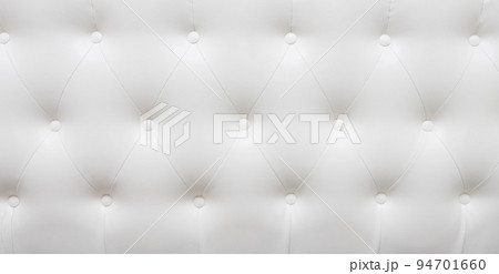 Beautiful white leather upholstery sofa with buttons. Skin texture. Beautiful white leather upholstery sofa with buttons. Skin texture. 94701660