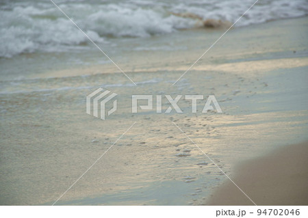 salt water sea impact to beach with reflection of sunlight  94702046