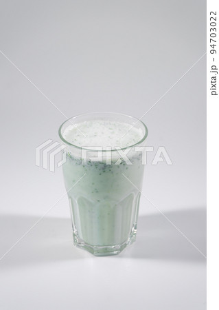 glass with fresh matsoni with greens and cucumber isolated on white background 94703022