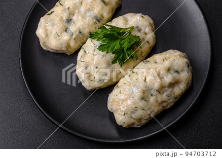 Traditional Lithuanian dish zeppelin, boiled potato dumplings stuffed with minced meat 94703712