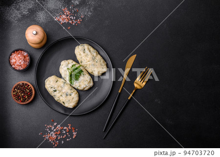 Traditional Lithuanian dish zeppelin, boiled potato dumplings stuffed with minced meat 94703720