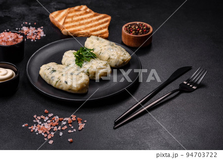 Traditional Lithuanian dish zeppelin, boiled potato dumplings stuffed with minced meat 94703722
