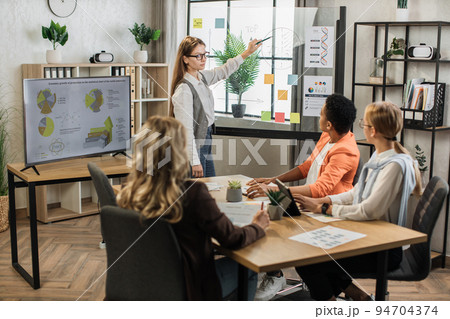 Multiracial female business people having briefing about financial situation at company. 94704374