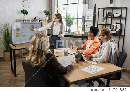 Team of four financial female experts gathering at conference room for discussing common project. Team of four financial female experts gathering at conference room for discussing common project. 94704385