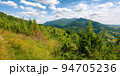 beauty of carpathian mountain landscape in summer. wonderful green countryside scenery on a sunny day. forested hills and grassy meadows beneath a blue sky fluffy clouds 94705236