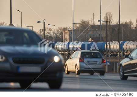 Road and rail transportation, oil freight wagons and cars passing 94705490